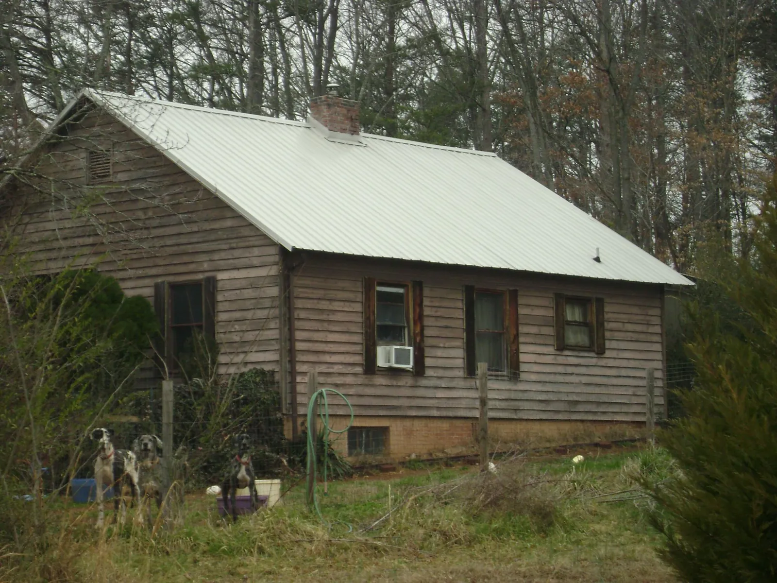 White metal roof on an old wood sided farmhouse, from a Asphalt Shingle Roof Repair job in Silver Spring